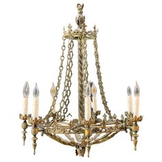 an antique chandelier with candles and chains