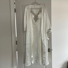 Beautiful, Never Worn Flora Bridal Gown And Robe. Size S. Gown: Lace Accents With Mesh On The Back. Bust Has Cups. Robe: Lace Accents On Sleeve. Full Length. String Closure. Original Price $134. Tags Still Attached. Selling As A Set. White Silk Kaftan For Festive Occasions, Elegant Robe For Mother Of The Bride, White Silk Wedding Nightgown, Floor-length White Nightgown For Wedding Night, White Satin Evening Robe, White Floor-length Nightgown For Wedding Night, White Silk Robe For Wedding Night, White Silk Wedding Night Robe, Elegant Silk Nightgown For Wedding