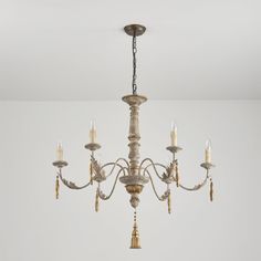 a chandelier hanging from the ceiling in a room with white walls and flooring