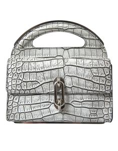 Featuring a chic leather top handle, this mini bag opens to a black inner lining. Craftsmanship is apparent in every detail, reflecting Balenciaga’s luxury and style. Made in Italy     Material: 100% Alligator skin Leather  Color: Silver  Country of origin: Italy  Logo details  Dimensions: 21cm x 20.5cm x 8.5cm Balenciaga Couture, Skins Mini, Italy Logo, San Sebastian Spain, Leather Mini Bag, Balenciaga Leather, Cristóbal Balenciaga, Alligator Skin, Chic Leather