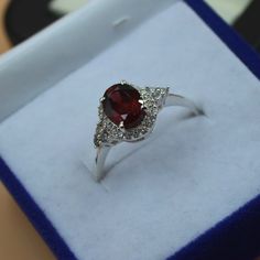 Red Birthstone Ring With Center Stone As Gift, Red Crystal Ring With Stone Setting For Anniversary, Classic Red Crystal Ring For Gift, Classic Red Crystal Ring As A Gift, Classic Red Crystal Ring Gift, Oval Ruby Crystal Ring As Gift, Oval Ruby Ring Gift, Ruby Rings With Stones As Gift, Ruby Rings With Stones For Gift