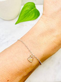 "This beautiful mustard seed flower bracelet is perfect for any occasion!  \"If you had faith even as small as a mustard seed, you could say to this mountain, \"move from here to there.\" and it would move. Nothing would be impossible for you.\" - Matthew 17:20 Share your faith and the love of God everywhere you go! This beautiful handmade resin bracelet makes the perfect gift for your best friend, mom, sister, or just a reminder of your own inner beauty and faith.  Bracelet is handmade with resin, real flowers, mustard seeds, and your choice of either silver plated or sterling silver chain.  SIZES I offer a variety of sizes, if you do not see the size you need please let me know and I can make any custom size you require. The size pictured in the photos is the 7 inch silver plated chain. Dainty Yellow Bracelet As Gift, Spiritual Heart Charm Bracelet For Gift, Dainty Yellow Bracelet For Gift, Spiritual Heart Bracelet With Charm As Gift, Spiritual Heart Bracelet With Heart Charm For Gift, Mother's Day Gift Heart Bracelet With Lobster Clasp, Mother's Day Heart Bracelet With Lobster Clasp, Mustard Seed Necklace Diy, Dainty Yellow Bracelet