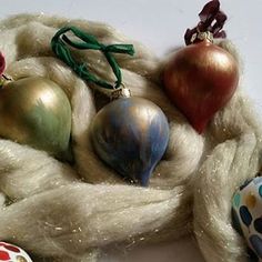 an assortment of ornaments are displayed on a white surface