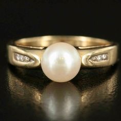 14K Gold Pearl and Diamond Ring looks beautiful and in Excellent Condition.  ** This Ring has been Authenticated and cleaned by a GIA Graduate Gemologist and Jeweler. Guaranteed Authentic. **See below for more Details: Materials: 14K Gold Ring Size: 7.50 Hallmarks: 14K JJ Total Weight (grams): 3.60 Primary Stone(s) Type: Cultured Pearl Primary Stone(s) Shape: Round Primary Stone(s) Dimensions: 7.00 mm Secondary Stone(s) Type: Diamond Secondary Stone(s) Shape: Round Brilliant Cut Secondary(s) Sto Pearl And Diamond Ring, 14k Gold Ring, Multi Stone Ring, Multi Stone, Gold Pearl, Ring Size 7, Pearl Ring, Cultured Pearls, Off Sale