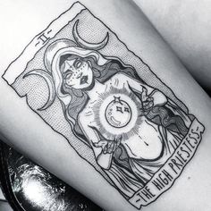 a tattoo on the thigh of a woman with a clock in her hand and moon above it