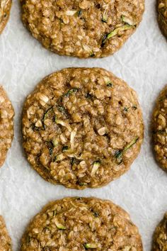 oatmeal cookies are arranged on a sheet of wax paper and placed next to each other