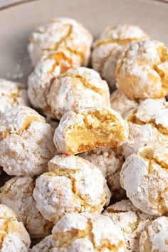 powdered sugar covered donuts in a bowl