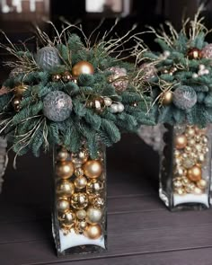 two vases filled with ornaments on top of a table