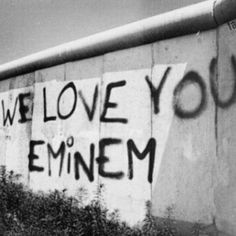 graffiti on the side of a building that says we love you emiem