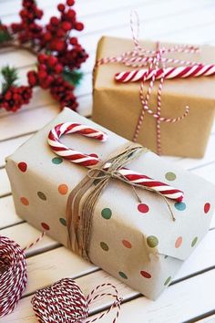 two wrapped presents sitting on top of a wooden table