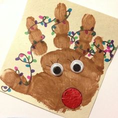 a paper plate with a handprinted reindeer on it's face and eyes