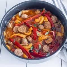 a pan filled with meat and vegetables on top of a table