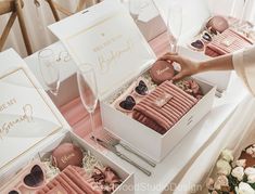 a table topped with boxes filled with cookies and wine glasses