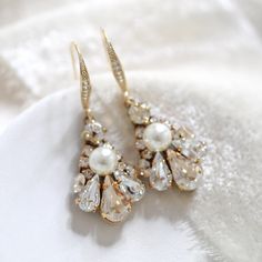 Simple and delicate crystal Bridal earrings created by hand for each bride. These are a great choice for a simple accent on your wedding day but still has lots of sparkle. - Handcrafted with Premium European crystals and pearls - Each stone is set by hand in my studio - Golden shadow and clear stones with cream pearl accents - Antique gold finish - Earring wire is studded with cz stones - Earrings measure 1.5 inches x 1/2 inch - Handcrafted in the US. - Nickel free and hypoallergenic PLEASE ALLO Gold Cubic Zirconia Crystal Earrings With Elegant Design, Elegant Gold Crystal Earrings For Anniversary, Gold Jeweled Bridal Earrings For Wedding, Elegant White Diamond Earrings For Wedding, Exquisite Jeweled Earrings For Wedding, Wedding Crystal Cluster Earrings With Sparkling Stones, Wedding Cluster Earrings With Sparkling Crystal Stones, White Cubic Zirconia Chandelier Earrings For Wedding, Elegant Drop Diamond Earrings For Wedding