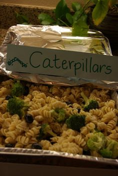 a container filled with pasta and broccoli on top of a counter