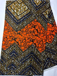 an orange and blue patterned tie sitting on top of a white table