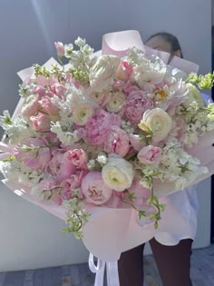 a bouquet of pink and white flowers on display