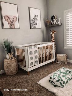 a baby's room with grey walls and pictures on the wall