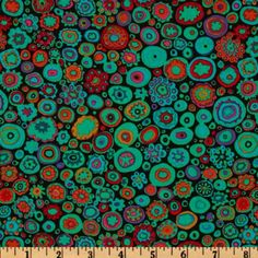 an image of colorful circles and dots on black background, with a ruler in the foreground