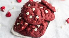 a pile of red velvet cookies with white chocolate chips