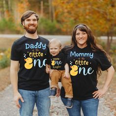 a man, woman and baby wearing matching shirts