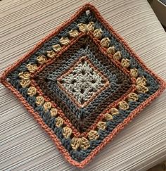 a crocheted square sitting on top of a table