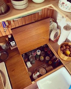 an overhead view of a kitchen with many items in the cabinet and on the counter