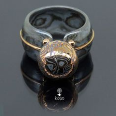 "This is a unique Au14K, Titanium mokume gane, Au14K/Ag925 mokume gane ring. Koan mokume gane jewellery My name is Andrew Seginovich, designer, maker and creator of Koan Mokume gane Jewelry. Welcome to my shop! The studio was created in 2005, and since that time I've been seeking the most interesting, inspiring and beautiful designs to make you happy. I hope you will enjoy my work and I promise to do my best to make you satisfied. The main technique I work in is mokume gane - wooden texture in m Unique Carved Ceremonial Jewelry, Ceremonial Hand-strung Jewelry, Mokume Gane Polymer Clay Tutorial, Mokume Gane Rings, Mokume Gane Ring Wedding, Mokume Gane Ring, Wooden Texture, Mokume Gane, Textured Ring