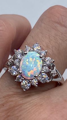 Vintage Ethiopian Opal Band 925 Sterling Silver Ring All pave set Cubic Zirconia and Ethiopian opal in Rhodium Sterling Silver to prevent tarnish Size 6, 7, 8 or 9.25 Can be re sized for a $10-$20 fee PLEASE add ring size to notes in your order!! Thanks. All rings are shipped in a nice gift box. Check out our over a THOUSAND great reviews Engraving is $4 per letter and is not always perfect depending on the piece. It can take a few days if the jeweler is busy. This is payable to Paypal Judithslt Elegant Silver Opal Ring With Cubic Zirconia, Silver Multi-stone Opal Ring As Gift, Silver Opal Ring Fine Jewelry, Silver Opal Rings With Center Stone, Opal Jewelry With Center Stone In White Gold, White Gold Opal Jewelry With Center Stone, Silver Opal Ring With Cubic Zirconia Center Stone, Formal Silver Opal Ring With Center Stone, Silver Multi-stone Opal Ring In Fine Jewelry Style