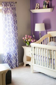 a nursery room with purple walls and white crib bedding in the foreground reads nursery must have's fitted crib sheets