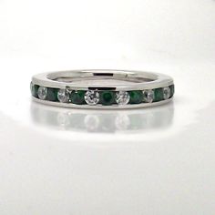 Beautiful cz diamond and cz emerald eternity ring.  These white and green cz stones are alternated throughout the ring to form an eternity band.  The ring is crafted from sterling silver and plated with white gold. Specification Metal:  925 Sterling Silver, plated with white gold (aka rhodium) Setting:  Channel Setting Width:  3mm Gemstone:  lab created diamond gemstones (CZ) Please allow 4-6 weeks production leadtime for this custom ring.  We can make this ring with other gemstones. Thank you f Emerald Eternity Ring, Channel Setting, Stack Ring, Eternity Wedding Band, Cz Diamond, Sterling Silver Studs, Sterling Silver Earrings Studs, Lab Created Diamonds, Eternity Bands