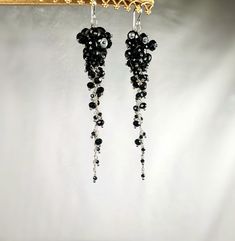 These black spinel earrings are designed in sterling silver with 3.5 inches of cascading gemstones.  These earrings are elegant and designed using three different sized stones for a tapered stiletto design.  Bold and flashy, these earrings make a great gift or the perfect statement piece in your own collection. Elegant Black Beaded Chandelier Earrings, Elegant Black Long Drop Chandelier Earrings, Black Sterling Silver Dangle Chandelier Earrings, Black Sterling Silver Chandelier Dangle Earrings, Elegant Black Chandelier Earrings With Ear Wire, Black Sterling Silver Dangle Crystal Earrings, Elegant Black Crystal Earrings In Sterling Silver, Elegant Sterling Silver Jewelry With Black Beads, Spinel Earrings