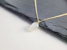 Add a touch of elegance with this handmade necklace, featuring a natural genuine White Moonstone gemstone dangling on a simple dainty chain. Choose your length for a choice to wear it as a choker or a long layered necklace. Simple, minimal, and elegant all-in-one necklace. Makes a great gift to add to any gemstone lover's collection. Perfect to gift for Christmas, Valentine's Day, Mother's Day, and more! Gemstone: Gray Moonstone Gemstone Size: 8.0 X 12.0 mm Gemstone Shape: Teardrop, Smooth, Half Minimalist White Dangle Drop Necklace, Minimalist White Long Drop Necklace, White Minimalist Dangle Drop Necklace, Minimalist Long Drop White Necklace, Minimalist Teardrop Crystal Necklaces, Elegant Moonstone Drop Necklace, Minimalist Teardrop Pendant Crystal Necklace, Minimalist Moonstone Necklace With Delicate Chain, Moonstone Pendant Necklace