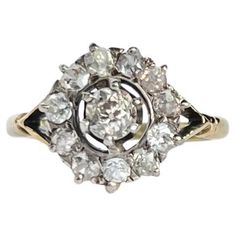 This stunning cluster ring holds old mine cut diamonds set within the platinum setting. The central stone measures approx 30pts and is surrounded by a halo of smaller old mine cut diamonds. The head is sat on a simple 18carat gold band with split shoulders and the diamonds total approx 1.07pts. Ring Size: K or 5 1/4 Cluster Diameter: 11mm Height Off Finger: 6mm Weight: 2.8g Old Mine Cut Diamond, Gold Mining, Cluster Ring, Gold Bands, Gold Diamond, Diamond Cuts, Halo, Platinum, Jewelry Rings