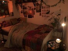 a bed sitting in a bedroom next to a window with candles on top of it