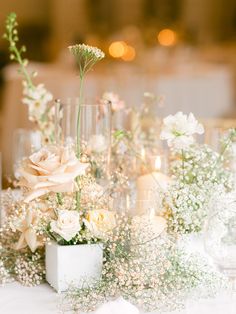 the centerpieces are arranged in vases with flowers and baby's breath