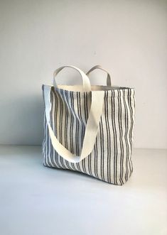 Medium Shopping Bag, Grocery, Weekender, beach, carry all, cotton/stripes. -- 100% natural, medium weight cotton fabric, cotton comfy strap. -- measures 13.75" x 5.10" x H 13.40" (35 x 13 x H 34 cm). -- The long/short handle.  this bag has a Long Shoulder Strap and Short Handle.  No matter how you want to carry it, it gives you the most utility, and comfort. -- two inner pockets for your wallet, cell phone, and more.  -- easy care, Foldable & washable. It is easy to place this bag in the handbag, backpack, kitchen drawer to save space. It can be washed and reused at will. -- choose a stylish and environmentally friendly cotton bag to protect our planet. -- Multipurpose. This bag can be used as groceries, baked goods, books, clothing, etc.. Can also be used as weekend tote bag,  for travel, Striped Tote Beach Bag For Everyday, Everyday Striped Tote Beach Bag, Cotton Tote Bag With Striped Lining, Casual Striped Beach Bag For Everyday Use, Everyday Striped Canvas Bag, Casual Striped Beach Bag, White Cotton Beach Bag, Travel Bags With Striped Cotton Material, Travel Bags With Striped Cotton Design