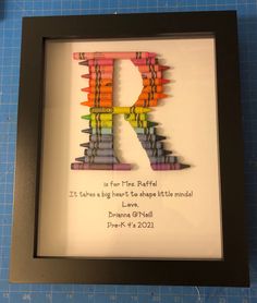 the letter r made out of crayons is displayed in a shadow box frame