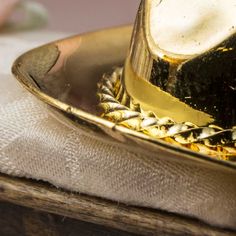 Miniature Gold Brass Cowboy Hat. Whether you are a cowboy or cowgirl, this Miniature Brass Cowboy Hat guarantees to bring a smile to the western lover in all of us!    Let this tiny accessory reside in your wee dollhouse world or sit upon your personal life-size desk! Use as a special western themed party favor. Add it to your fairy garden, terrarium, or dioramas.    Miniature collectors and crafters, alike, will appreciate its detailed features, and antiquated finish.    Dollhouse miniatures ar Western Themed Party, Fairy Garden Terrarium, Western Themed Wedding, Western Theme Party, Garden Terrarium, Western Theme, Factory Direct Craft, Gold Brass, Cowboy Hat