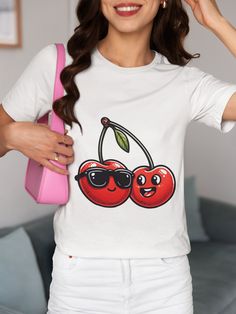 Step up your style game with our unique "Fun Cherry Sunglasses" T-shirt. Perfect for both men and women, this tee brings a dash of humor with its playful cherry characters donning cool sunglasses. Made from high-quality, soft fabric, it ensures comfort all day long. Whether you're out for a casual meet-up or a fun party, this shirt is sure to catch some eyes and spark smiles. Ideal for fruit lovers and those who appreciate a good laugh, it makes an excellent gift for various occasions. Pair it with your favorite jeans for a laid-back look or layer it under a jacket for cooler days. We utilize the authentic Bella Canvas 3001 brand, renowned for its UNISEX design, making it one of the most sought-after shirts in the market. Prior to placing an order, kindly refer to our size chart. It can be Cool White T-shirt With Funny Print, Funny Crew Neck T-shirt With Sublimation Print, Cool White Crew Neck T-shirt, Fun White T-shirt With Sublimation Print, Trendy T-shirt With Funny Print For Fans, Funny Sublimation Print Crew Neck Top, Cool Pre-shrunk Crew Neck T-shirt, Trendy White Top For Fan Merchandise, Casual Cotton Sublimation T-shirt With Funny Print