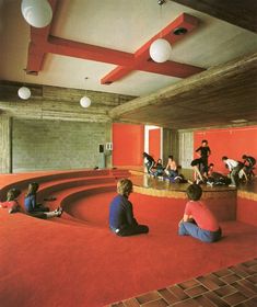 people are sitting on the floor in an empty room