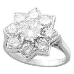 A stunning vintage 1940s 1.87 carat diamond and 18 karat white gold, platinum set floral cluster ring; part of our diverse diamond jewelry and estate jewelry collections. This stunning, fine and impressive vintage diamond ring has been crafted in 18k white gold with a platinum setting. The platinum set floral cluster design is ornamented with a central feature 0.82 Ct transitional modern brilliant round cut diamond, eight claw set in subtle relief. The feature diamond is surrounded by eight 'pet Vintage Cluster Ring, Vintage Diamond Ring, Cluster Design, Transitional Modern, Vintage Diamond Rings, Diamond Cluster Ring, Diamond Cluster, Ring Vintage, Vintage Diamond