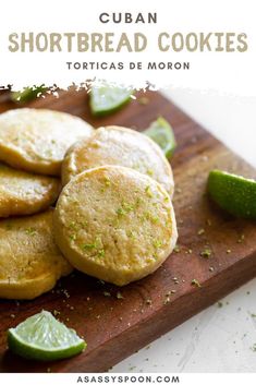 several shortbread cookies on a cutting board with limes