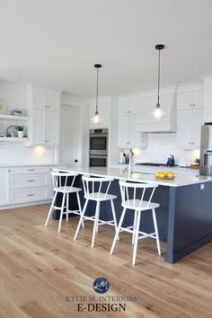 a kitchen with white cabinets and wooden floors