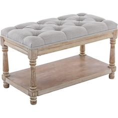 a wooden table with a gray cushion on top and two shelves below it that are also used as a coffee table or end table