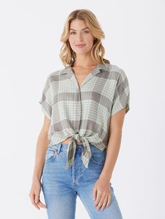 The Sheena Woven Button Up is crafted from 100% sustainable lenzing viscose for guilt-free fashion. It features a drop shoulder design and tie front detail, adding an elevated and stylish touch to any outfit. Casual Cotton Blouse With Tie Waist, Rayon Button-up Beach Top, Button-up Rayon Top For Beach, Beach Button-up Rayon Top, Casual Cotton Shirt With Tie Sleeves, Casual Viscose Tops With Button Closure, Casual Button-up Viscose Tops, Casual Viscose Shirt With Button Closure, Casual Short Sleeve Blouse With Tie Waist