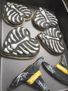 decorated cookies in the shape of skeletons on a baking sheet