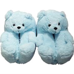 two blue teddy bears sitting next to each other