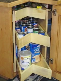 an open cabinet with canned food in it