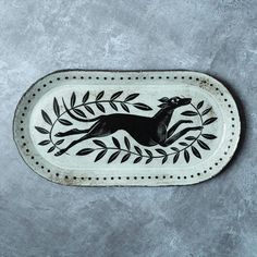 a black and white tray with an animal on it